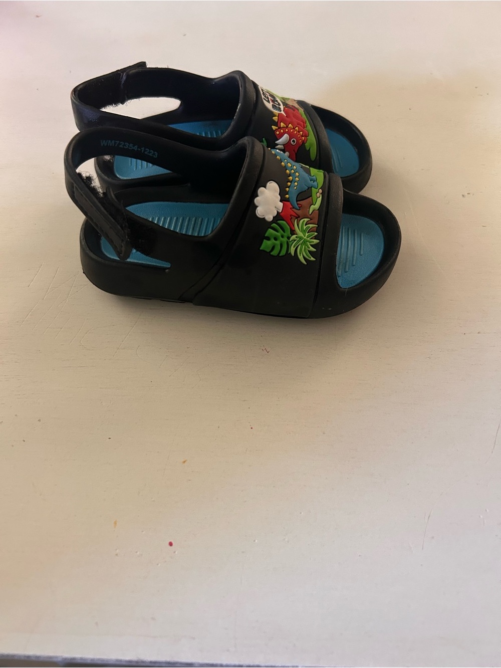 CROCS Black Kids Sandals with Blue Insole and Dino Accents